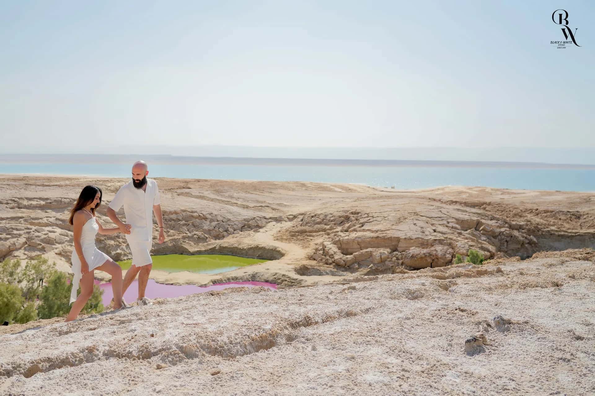A couple on the salt shore of the Dead Sea
