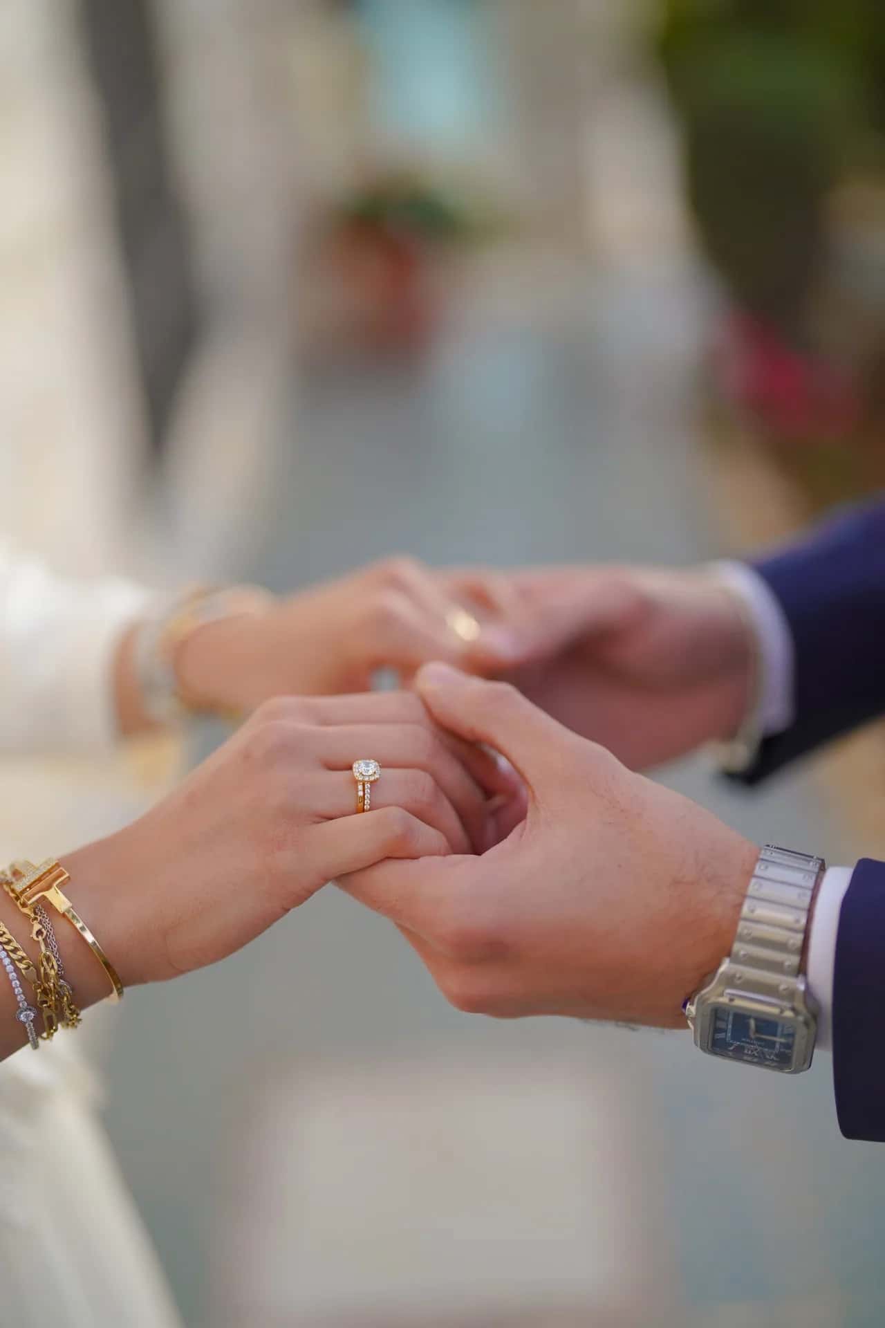 A groom placing a ring on his bride's finger