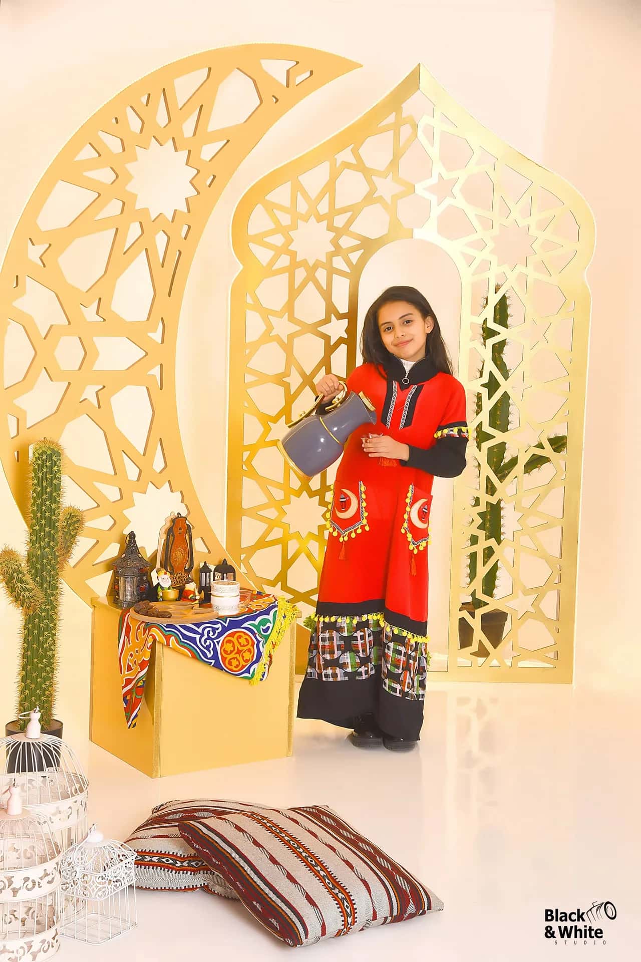 A girl in a red dress in the studio's Ramadan set