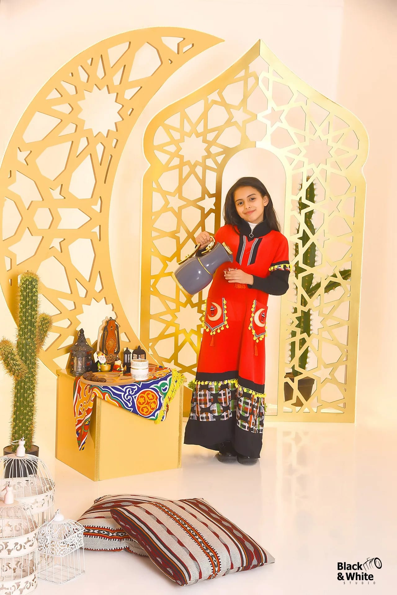 A girl in a red dress in the studio's Ramadan set