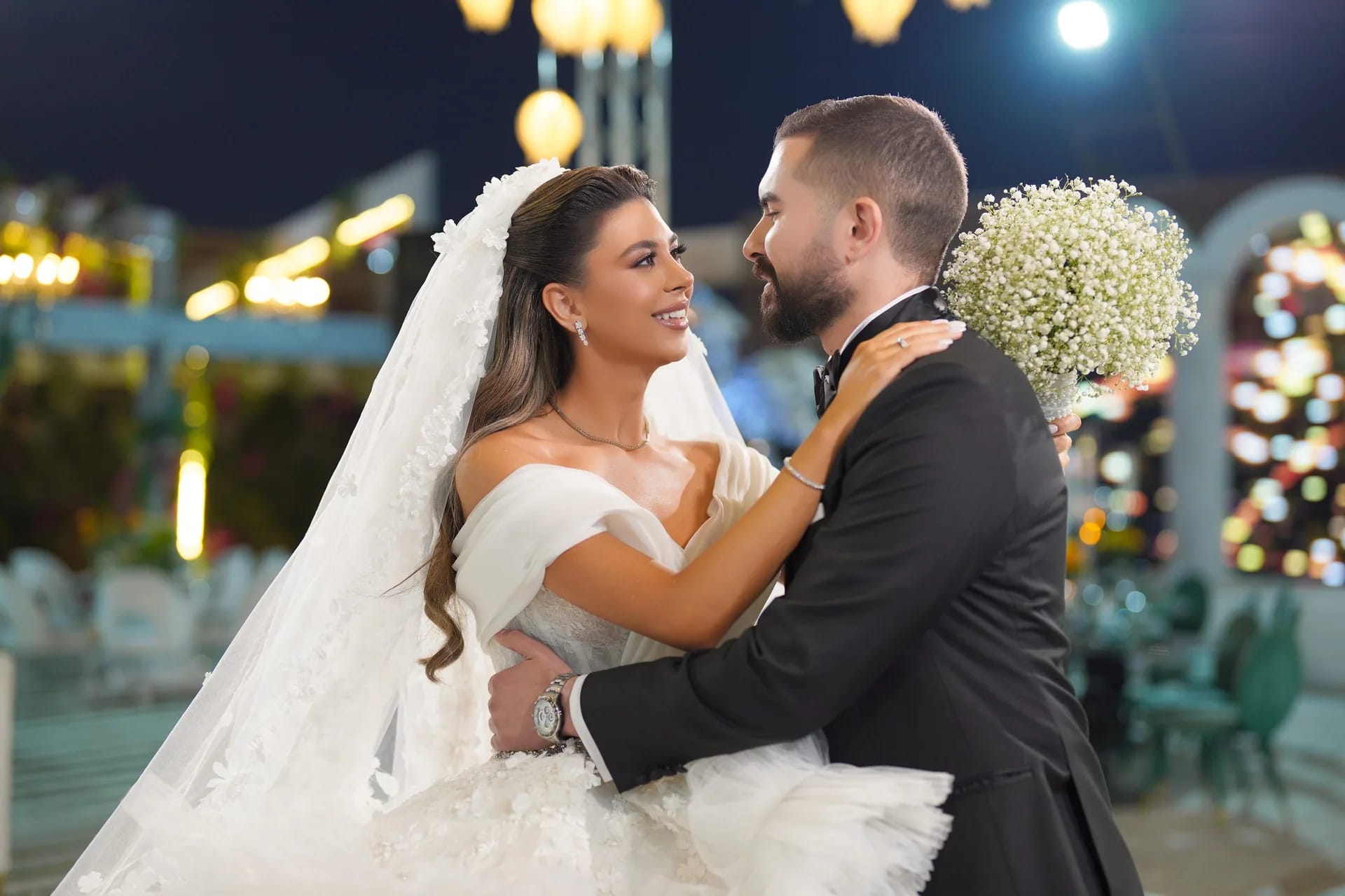 A couple embracing under evening lights