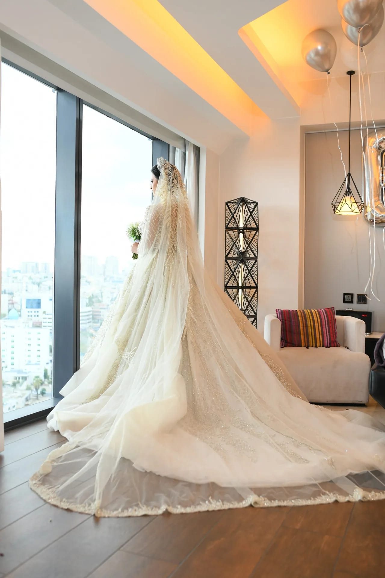 A wedding gown spread across a sunlit room