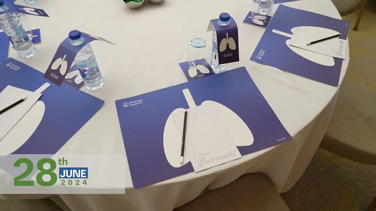 Conference tables set with branded place mats, 28 June 2024