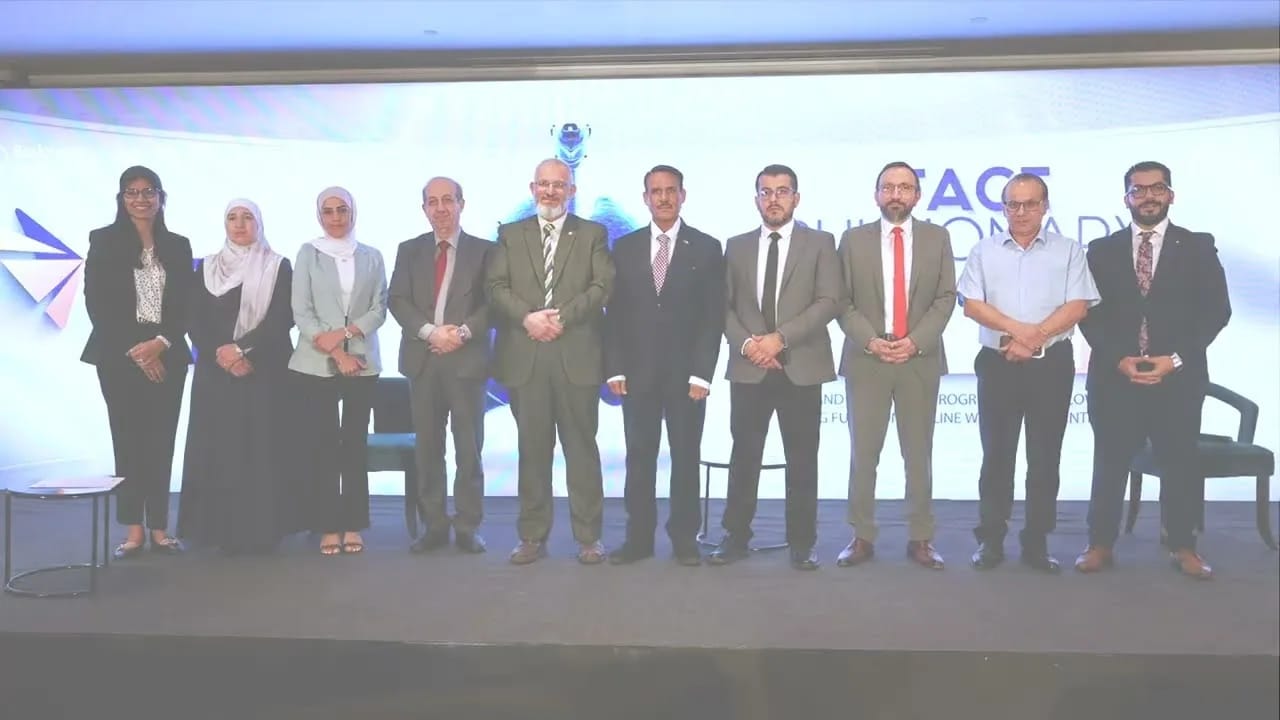Speakers and organisers standing together on a conference stage