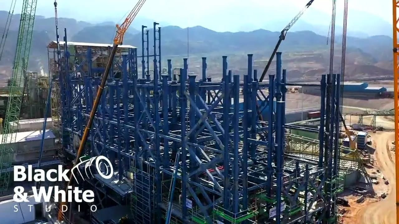 Steel structure rising on an industrial construction site among mountains