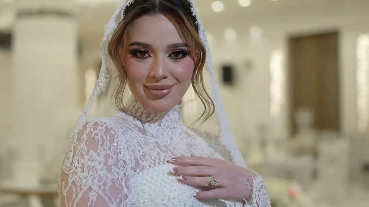 A bride in a lace veil, looking into the camera