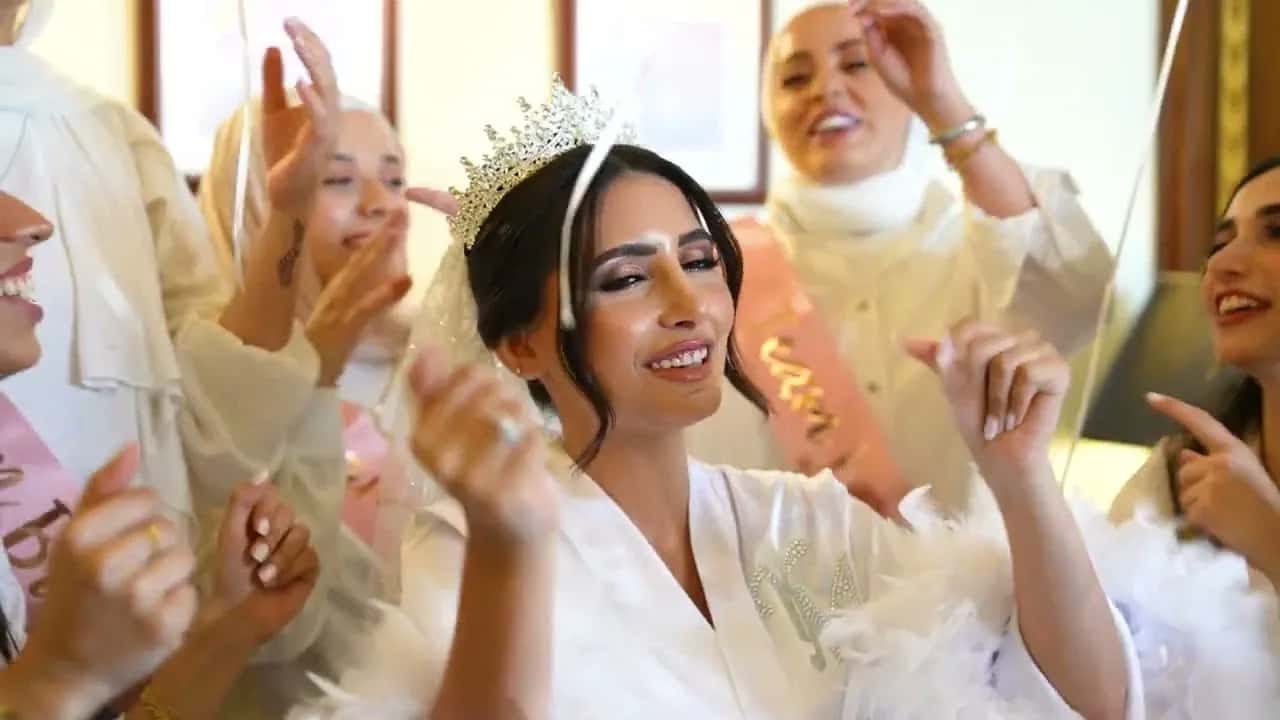 A bride in a crown, dancing among her friends